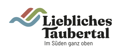 Tourismusverband Liebliches Taubertal Logo mit stilisierten, farbigen Linien und dem Text „Liebliches Taubertal Im Süden ganz oben“