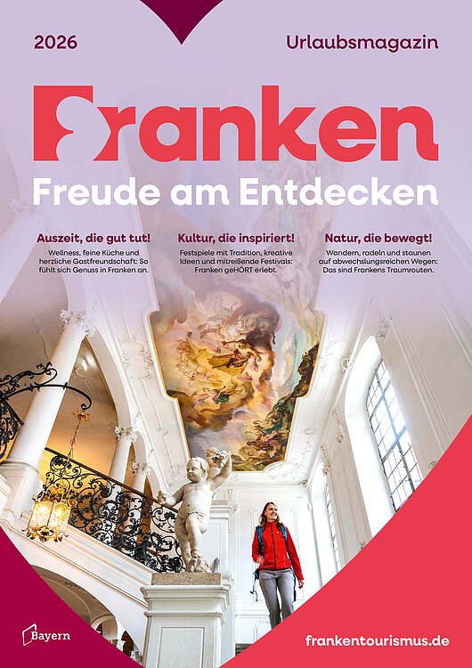 Cover-Seite mit Schriftzug "Franken Freude am Entdecken - Urlaubsmagazin" mit Bild einer Frau mit roter Jacke auf Treppe in barockem Gebäude mit Deckenfresko und Statue eines Putto